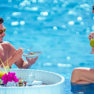 Atmosphere Kanifushi Maldives Honeymoon Packages Couples Enjoying Floating Breakfast